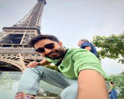 Paresh loves traveling and also shared as photograph of himself in front of <a href=